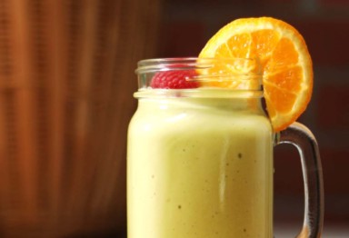 A smoothie with a slice of orange