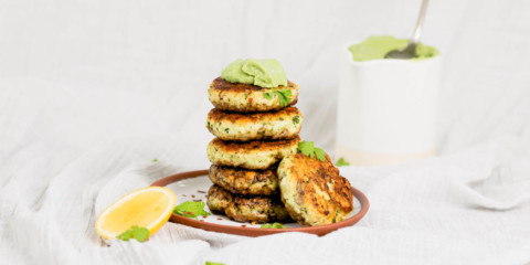 Stack of keto fish cakes with avocado lemon sauce