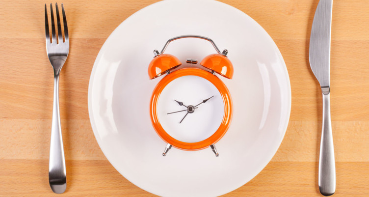 Orange clock on white plate