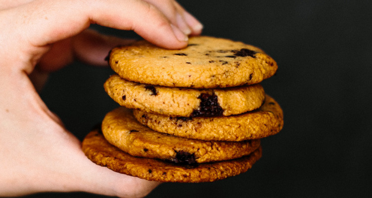 Hand holding chocolate chip cookies