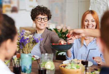 Friends and family gathered around a table enjoying a meal