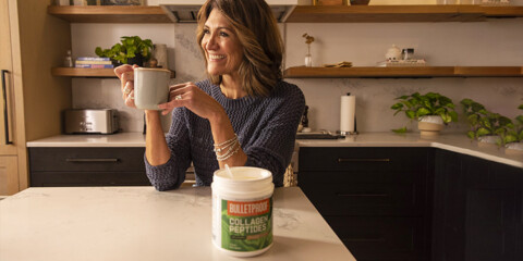 middle aged woman with great hair enjoying a cup of coffee