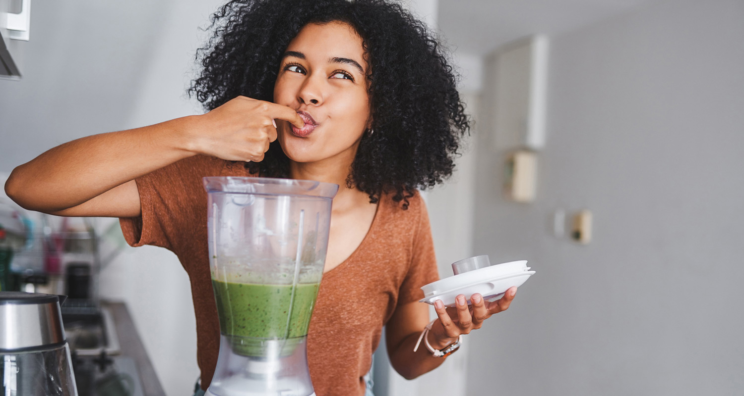 woman tasting a smoothie