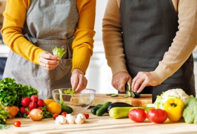 two people cutting vegetables