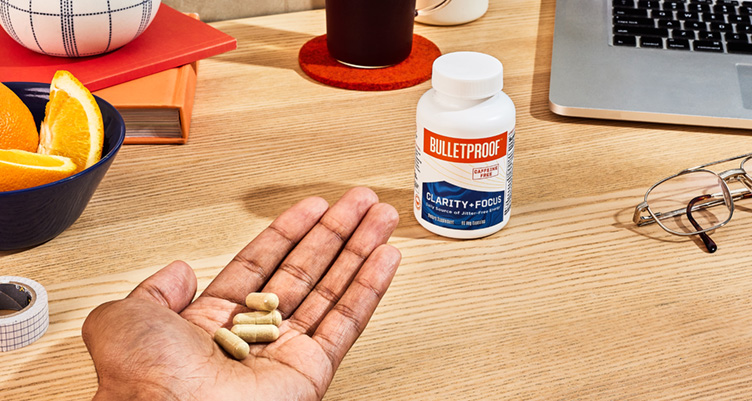 hand of supplements next to work space