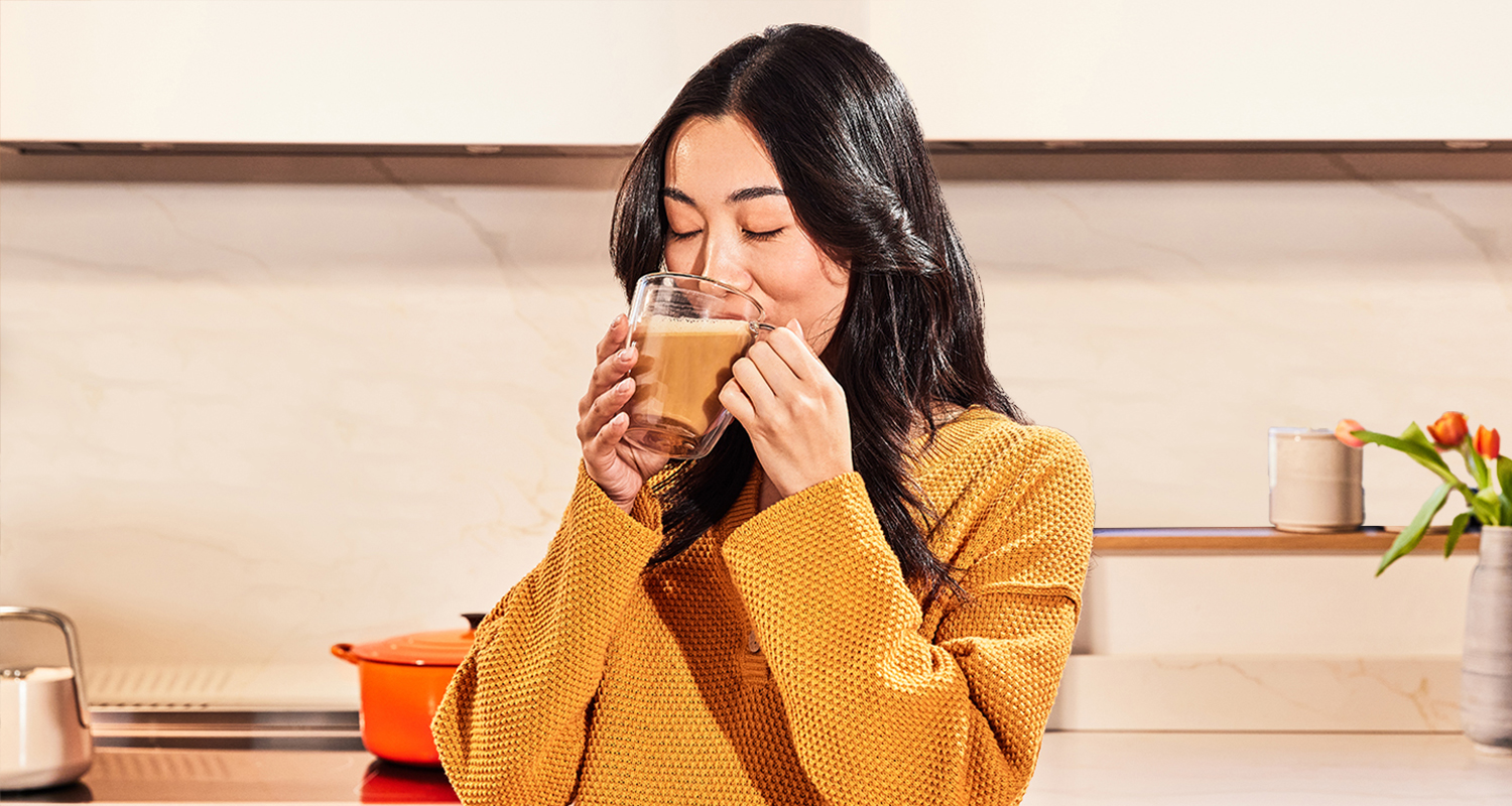 woman in yellow shirt drinking coffee