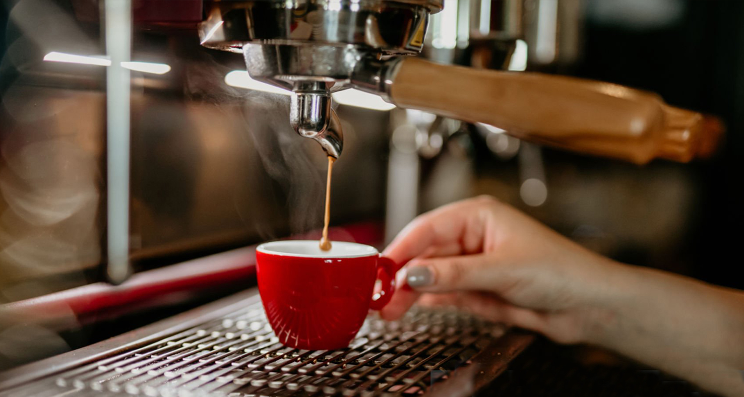 hands making a shot of espresso